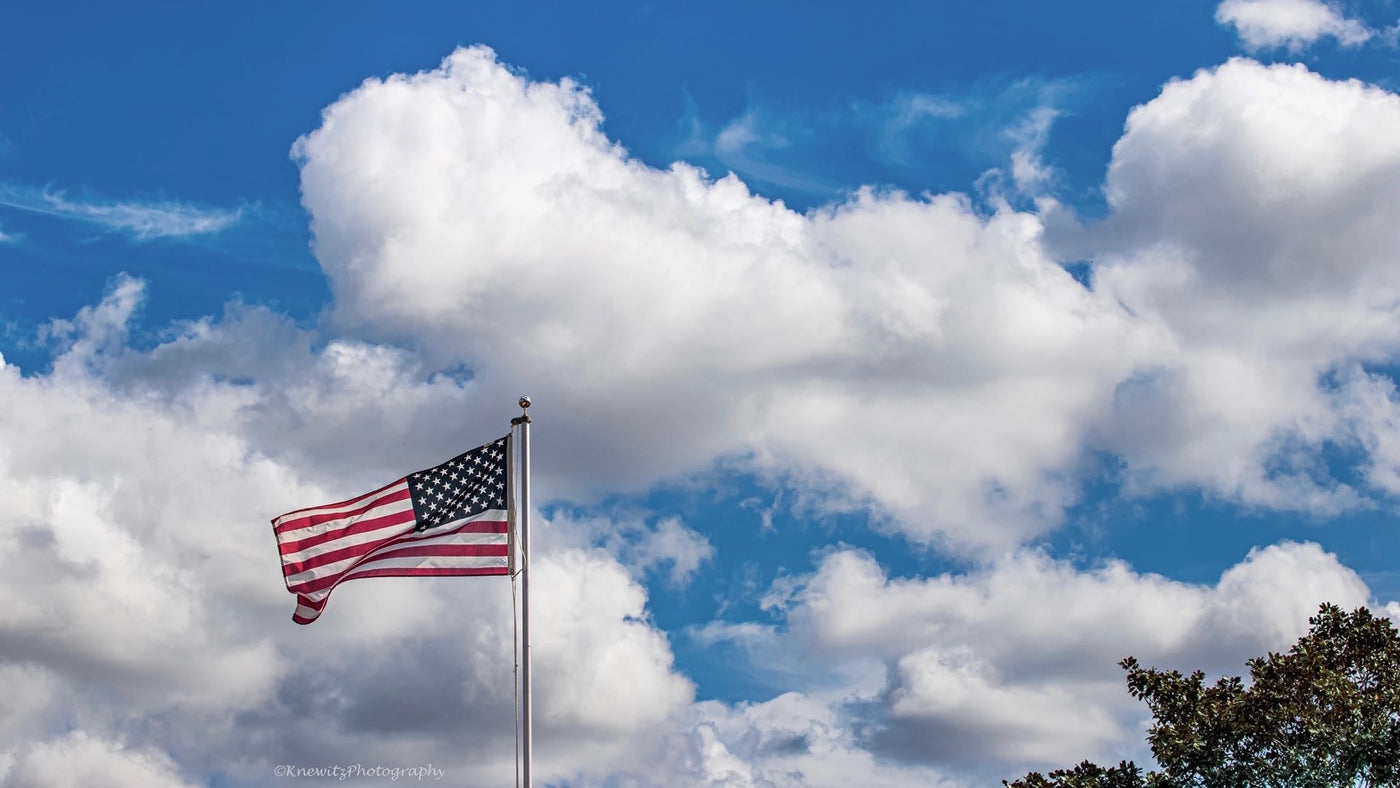 US Flag with white clouds